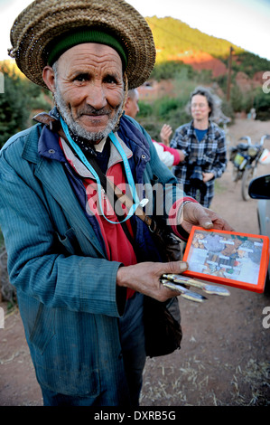 Portrait of old Moroccan Berber man holding and selling gemstones to tourists, Marrakech, Morocco, Stock Photo