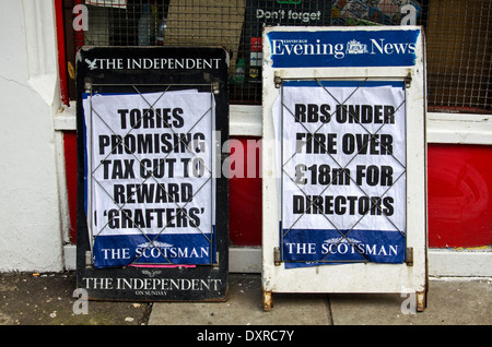 Newspaper A boards outside a newsagent in the centre of Edinburgh with news of tax cuts and RBS Directors. Stock Photo