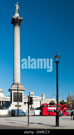 Nelson's Column in Trafalgar Square London with red routemaster Hybrid bus Stock Photo