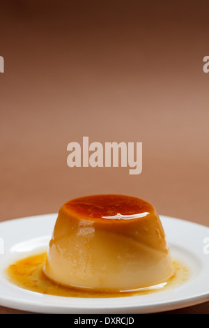 Caramel custard flan in a white plate Stock Photo