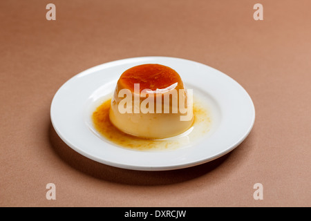 Creme caramel on white plate