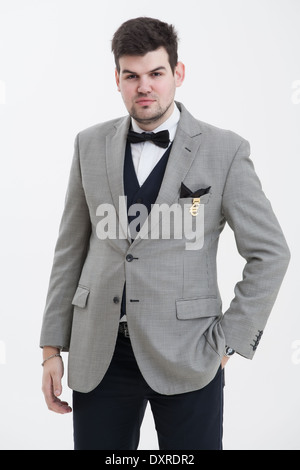 European businessman in triple suit. Handsome man. Euro logo icon pinned to the suit. Stock Photo