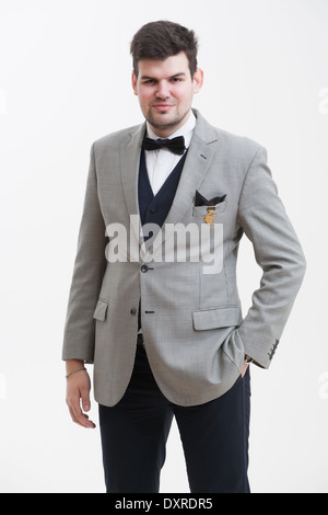 European businessman in triple suit. Handsome man. Euro logo icon pinned to the suit. Stock Photo