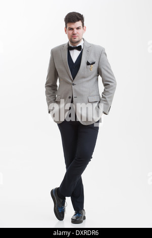 European businessman in triple suit. Handsome man. Euro logo icon pinned to the suit. Stock Photo