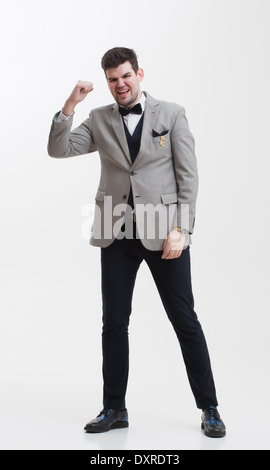 European businessman in triple suit. Handsome man. Euro logo icon pinned to the suit. Stock Photo