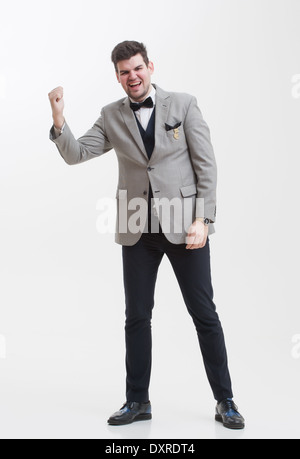 European businessman in triple suit. Handsome man. Euro logo icon pinned to the suit. Stock Photo