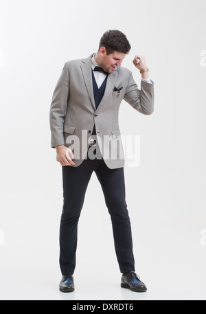 European businessman in triple suit. Handsome man. Euro logo icon pinned to the suit. Stock Photo