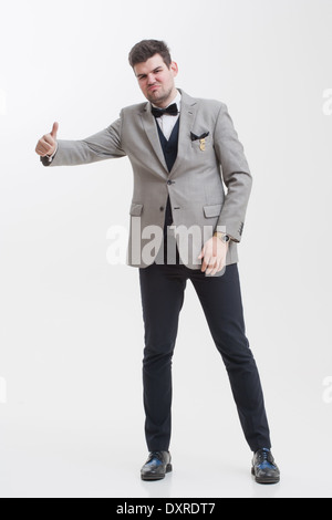 European businessman in triple suit. Handsome man. Euro logo icon pinned to the suit. Stock Photo