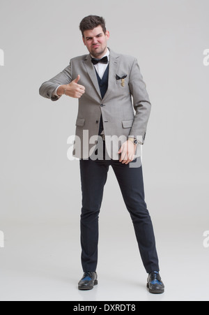 European businessman in triple suit. Handsome man. Euro logo icon pinned to the suit. Stock Photo