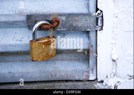 close up of rusty padlock on door Stock Photo