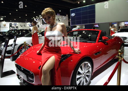 Bangkok, Thailand. 28th March 2014.  Presenter posing with Jaguar during The 35th Bangkok International Motor Show . The 35th Bangkok International Motor Show; will be held from March 26 to April 6 Credit:  John Vincent/Alamy Live News Stock Photo