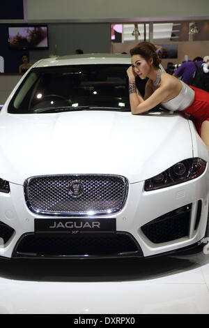 Bangkok, Thailand. 28th March 2014.  Presenter posing with Jaguar during The 35th Bangkok International Motor Show . The 35th Bangkok International Motor Show; will be held from March 26 to April 6 Credit:  John Vincent/Alamy Live News Stock Photo