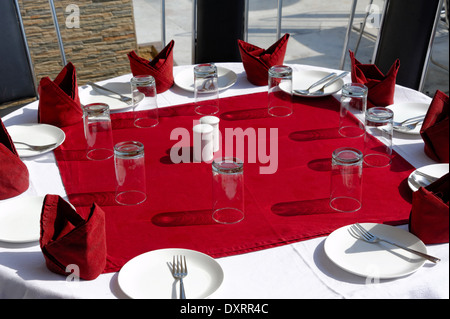 Table, glasses, forks, plates, napkins Stock Photo