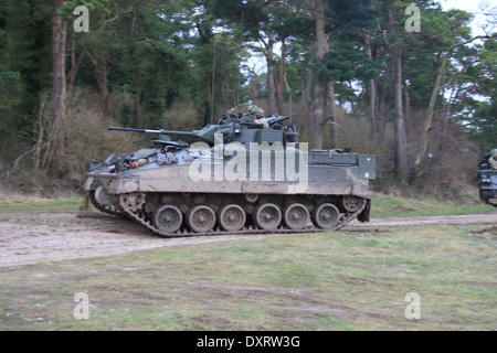 FV510 Warrior IFV traveling over rough terrain on Salisbury Plain Training Area during an exercise Stock Photo