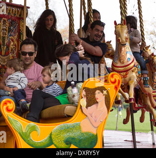 London, UK . 30th Mar, 2014. Families have fun together on the Jubilee Steam Gallopers - the first large ride bought by John and Anna Carter. Typically English, it was originally built by Robert Tidman & Sons of Norwich in 1895. Carters Steam Fair, Battersea Park, London, UK, on Sunday, 30 March, 2014. Carters Steam Fair is a vintage funfair that every year, since 1977, travels in towns and villages throughout London, the Home Counties and beyond with vintage heavy lorries and traditional showman's wagons. The Carter Family maintain a collection of rides and sidestalls, ranging in date from th Stock Photo