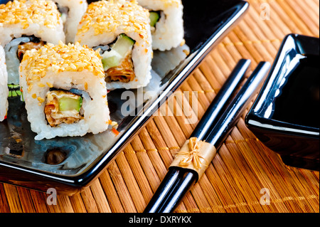 Japanese rolls on a beautiful black crockery Stock Photo