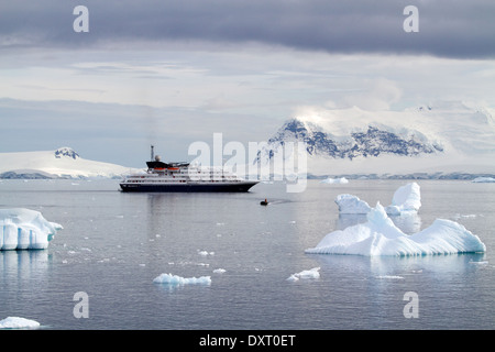 Antarctica cruise ship Antarctica expedition with tourists enjoy Antarctic landscape, Antarctic Peninsula. A zodiac leaves the ship Stock Photo