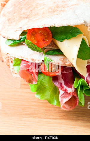 unleavened wheat cake with smoked meat and greens. Stock Photo