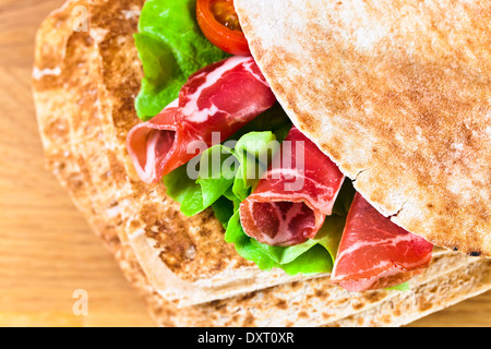 oriental bread with smoked meat and greens. Stock Photo