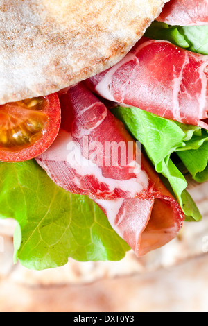 oriental bread with smoked meat and greens. Stock Photo