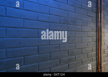 detail of gray brick wall with blue light Stock Photo