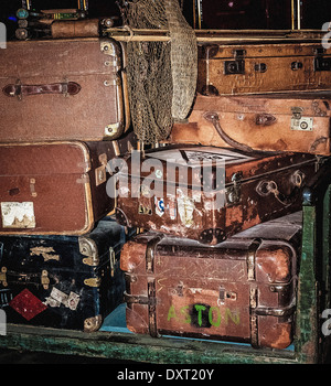 Pile of old fashioned suitcases on trolley Stock Photo