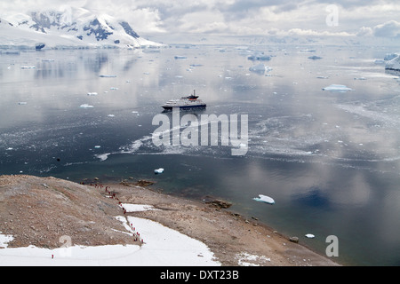 Antarctica cruise ship in Antarctica landscape expedition with tourists, Antarctic Peninsula, Neko Harbor, Harbour. Stock Photo