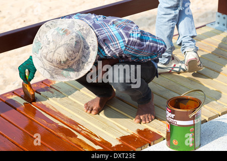 Painting a wooden Walkway in Pattaya, Thailand Stock Photo