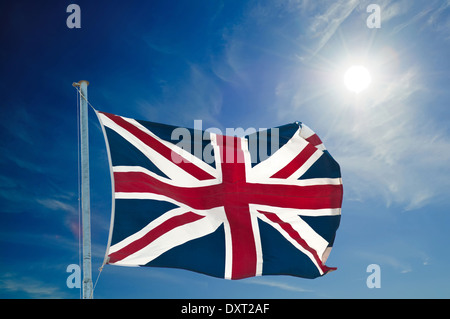 Union Jack flying high, against blue sky with copy space Stock Photo