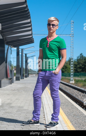 Stylish man with sun glasses standing on platform Stock Photo
