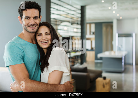 Portrait of happy couple hugging at home Stock Photo