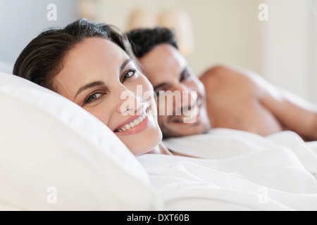 Close up portrait of happy couple in bed Stock Photo