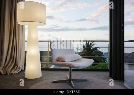 Modern floor lamp and chair in living room corner Stock Photo