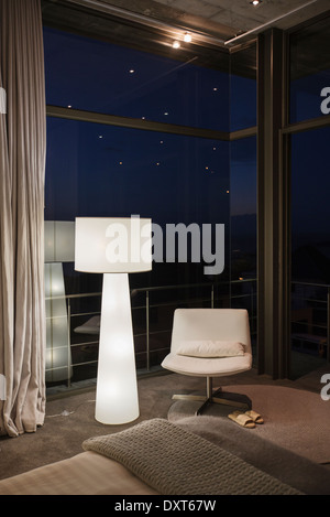 Lamp and chair in corner of modern bedroom Stock Photo
