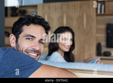 Portrait of smiling couple in living room Stock Photo