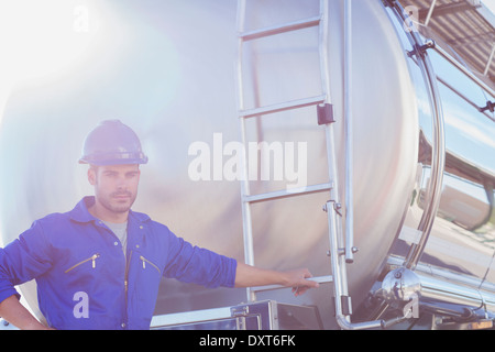 Portrait of worker at back of stainless steel milk tanker Stock Photo