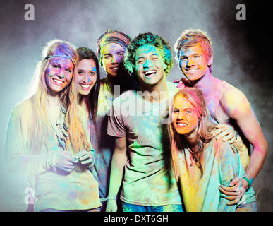 Portrait of friends covered in chalk dye at music festival Stock Photo