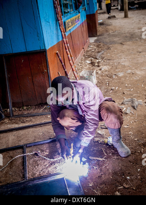 Welder in Kenya, Africa welds steel frames for doors and windows Stock Photo