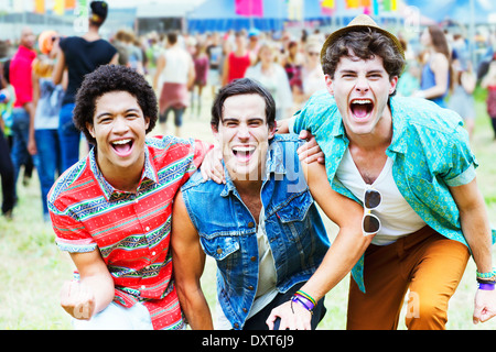 Enthusiastic men cheering at music festival Stock Photo