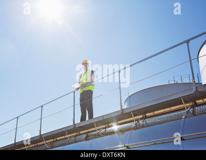 Worker on platform above milk tanker Stock Photo