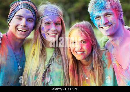 Close up portrait of friends covered in chalk dye at music festival Stock Photo