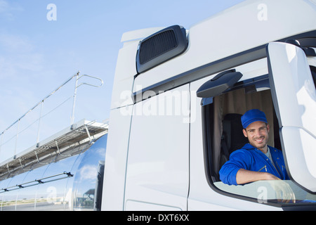 Portrait of smiling driver in milk tanker Stock Photo