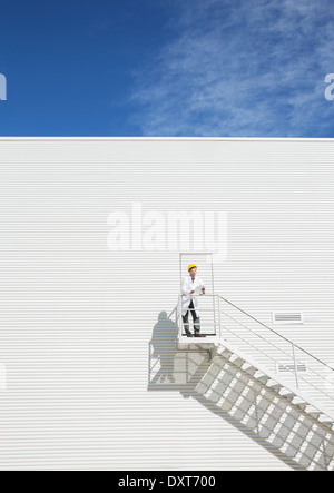 Scientist standing on platform against building Stock Photo