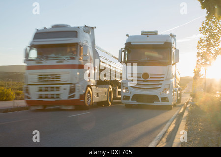 Stainless steel milk tankers on the road side by side Stock Photo
