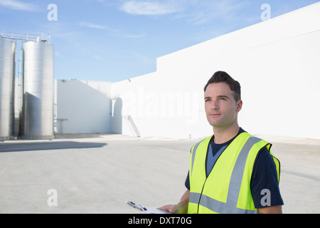Worker with clipboard at granary Stock Photo