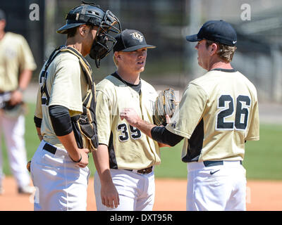 March 30, 2014 - Orlando, FL, U.S: UCF head coach Terry Rooney (26) visits the mound to talk with UCF catcher Jordan Savinon (29) and UCF pitcher Zach Rodgers (39) during NCAA baseball game action between the Temple Owls and the UCF Knights. UCF defeated Temple 12-5 at Jay Bergman Field in Orlando, FL Stock Photo