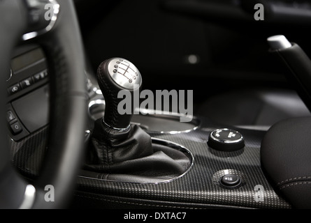 6 Speed Stick Shift - Modern Vehicle Interior in Black and White. Powerful Engine and Six Speed Transmission. Transportation Pho Stock Photo