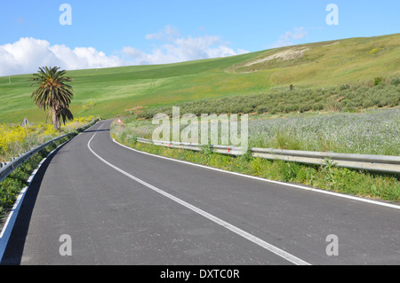 An Australian cyclist touring Sicily riding on the Strada Statale 187, East of Castellammare del Golfo, Sicily, Italy