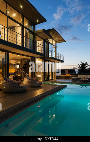 Luxury house with swimming pool illuminated at night Stock Photo