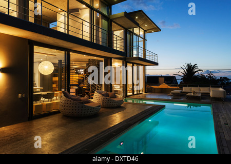 Luxury house with swimming pool illuminated at night Stock Photo
